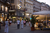 People walking through shopping street Graben in the evening, Vienna, Austria