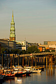 View at inner harbour with boats and steeple of church St. Katharinen, Hamburg, Germany