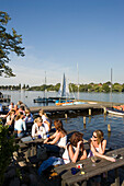 People sitting at Alster Cliff, People sitting in open-air area of Alster Cliff at lake Alster, Hamburg, Germany