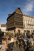 Place de la Cathedrale and Maison Kammerzell, View over a pavement cafe on Place de la Cathedrale Cathedral Square, to one of the oldest and loveliest timbered houses the Maison Kammerzell, Strasbourg, Alsace, France
