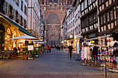 View through the Rue Merciere to the Our Lady's Cathedral, View through the Rue Merciere with a pavement cafe and a souvenir shop to the western facade of the Our Lady's Cathedral Cathedrale Notre-Dame, , Rue Merciere, Strasbourg, Alsace, France