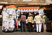 Women at a market stall for tableclothes, Women standing at a market stall for tableclothes, rear view, Buda, Budapest, Hungary