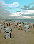 Hooded beach chairs on sandy beach, Timmendorfer Strand, Schleswig Holstein, Germany
