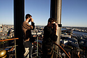 Tourists taking pictures on viewing plattform, steeple of St. Michaelis Church, river Elbe, Hamburg
