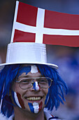 Soccer fan from Danmark, wearing hat with flag