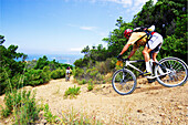 Mountainbiker races down to Corsicas westcoast, Corsica, Mediterranean, France