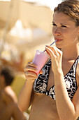 Young woman drinking milkshake