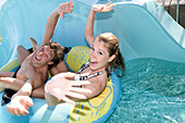 Couple having fun in water slide