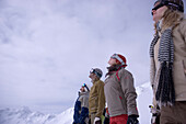 Group of young people standing on ski slope, in a row, Kuehtai, Tyrol, Austria