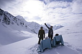 Two young people relaxing on lounge chairs, two others standing next them, Kuehtai, Tyrol, Austria