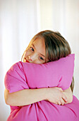 Girl hugging a cushion