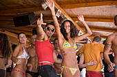 Young people dancing during a beach party at Tropicna Club, Paradise Beach, Mykonos, Greece