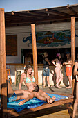 Young people relaxing during a beach party in a pool of the Paradise Club, Paradise Beach, Mykonos, Greece