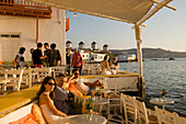 People sitting in restaurant directly at sea, Little Venice, Mykonos-Town, Mykonos, Greece