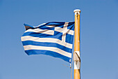 Greek flag fluttering in the wind, Mykonos, Greece