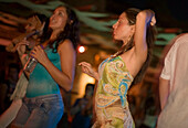 Young grils dancing by the full moon party of the Paradise Club, Paradise Beach, Mykonos, Greece