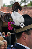 Man wearing traditional hat, decorated with Black Grouse feathers, Kochel, Upper Bavaria, Germany