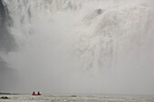 People on a canoo under the Virginia Falls, Nahanni River, Northwest Territories, Canada
