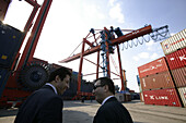 Two businessmen talking, container harbour, Istanbul, Turkey