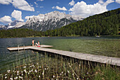 Two people on jetty, Lautersee in front of Karwendel, Werdenfelser Land, Upper Bavaria, Germany