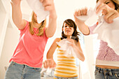 Teenage girls (14-16) throwing papers through the room