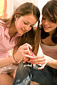 Teenage girls (14-16) painting their nails