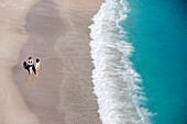 Women strolling along Shell Beach,Gustavia, St. Barths