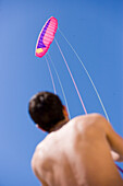 Young man holding kite string, Apulia, Italy