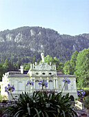 Linderhof castle in front of mountains in the sunlight, Bavaria, Germany, Europe
