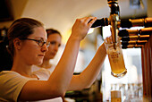 Barkeeper pouring beer, Hopfen Pub, Bolzano, Alto Adige, Italy