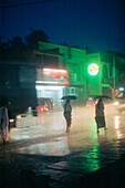 People with umbrellas, Beruwala, Sri Lanka