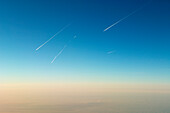 Several Aircraft with contrails overhead horizon