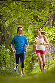 Couple jogging in woods