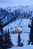View to illuminated alpine hut (Hochwurzenalm), Schladming, Ski Amade, Styria, Austria