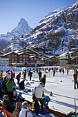 People curling on rink, Matterhorn in background, Zermatt, Valais, Switzerland
