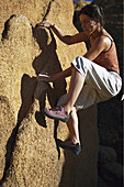 Woman bouldering, Tafraoute, Morocco