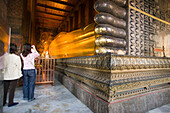 Tourists taking a picture of the golden Reclining Buddha, Wat Pho, The Temple of the Reclining Buddha, the largest and oldest wat in Bangkok, Bangkok, Thailand