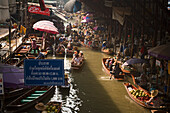 Tourists in wooden boats visiting the Floating Market, Damnoen Saduak, near Bangkok, Ratchaburi, Thailand