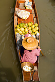 Woman in a wooden canoe at Floating Market, Damnoen Saduak, near Bangkok, Ratchaburi, Thailand
