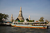 View over the river Menam Chao Phraya with ferry boat to Wat Arun, Temple of Dawn, Bangkok, Thailand