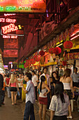 People walking over a night market along bars and clubs, Patpong, red light and entertainment district, Bang Rak district, Bangkok, Thailand