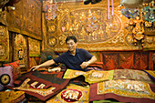 A dealer showing his goods, Suan Chatuchak Weekend Market, Bangkok, Thailand