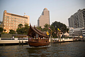 Ferry leaving pier, Hotel in background, Menam Chao Phraya River, Bangkok, Thailand