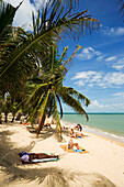 Vacationers sunbathing at Mae Nam Beach, Hat Mae Nam, Ko Samui, Thailand