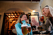 Two women drinking beer, street cafe, Bonifacio, Corse, France