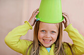 Girl (7 years) with bucket on head