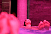 Woman lying in whirlpool, Hotel Krallerhof, Leogang, Salzburger Land, Austria