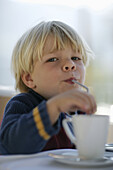 Young boy drinking with straw