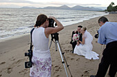 bride and groom, wedding, wedding photographer taking photos on Holloways Beach, nearby Cairns, Tropical North, Queensland, Australia