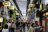 People at a canopied shopping arcade, Tokyo, Japan